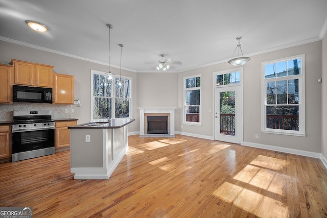 kitchen with pendant lighting, electric range, ornamental molding, and decorative backsplash