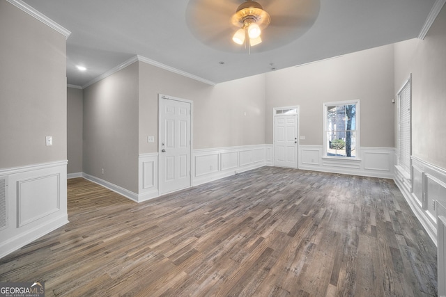 empty room with ornamental molding, dark hardwood / wood-style floors, and ceiling fan