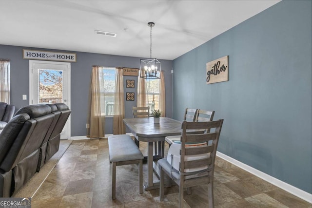 dining area featuring an inviting chandelier