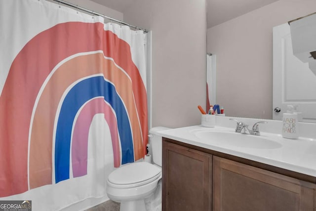 bathroom with vanity, toilet, and a shower with shower curtain