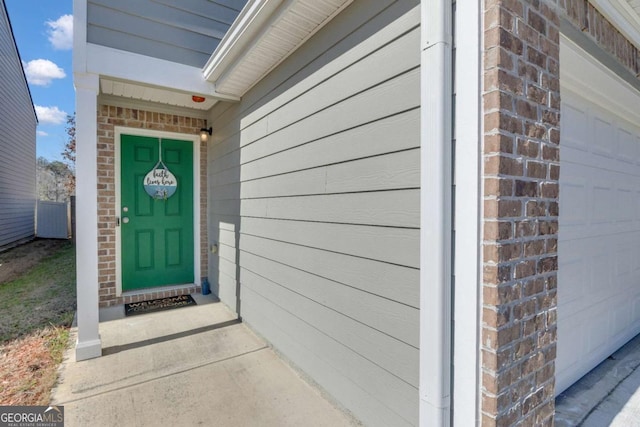 doorway to property with a garage