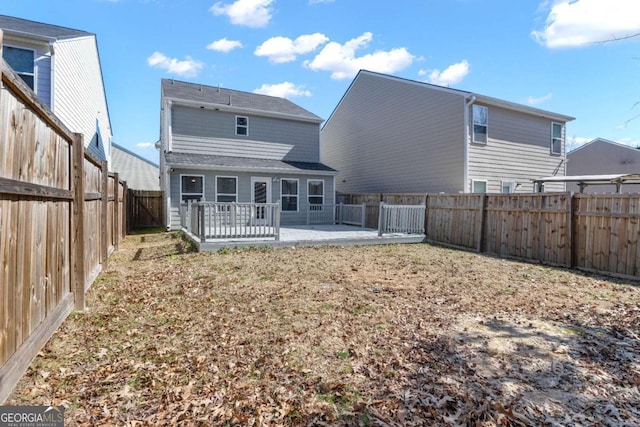 back of property with a patio and a wooden deck