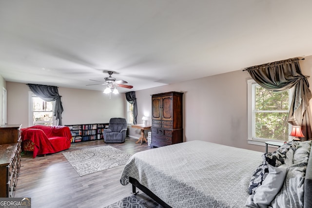 bedroom with ceiling fan and light hardwood / wood-style floors