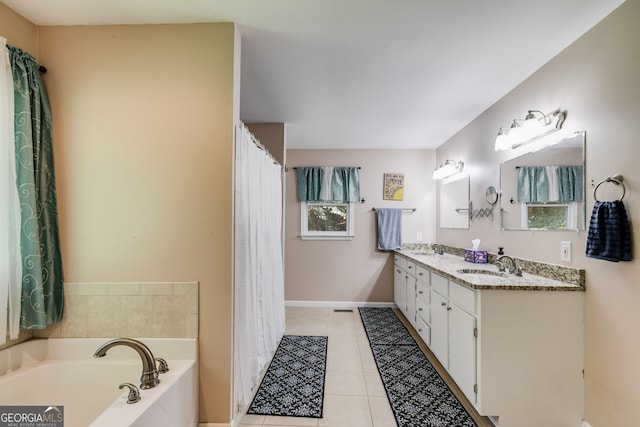 bathroom featuring tile patterned floors, a tub to relax in, and vanity