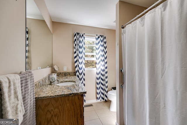 bathroom featuring vanity, tile patterned floors, and toilet