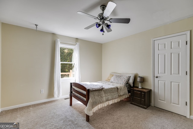 carpeted bedroom featuring ceiling fan