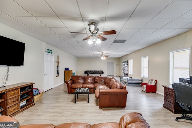 living room featuring a drop ceiling, light hardwood / wood-style flooring, and ceiling fan