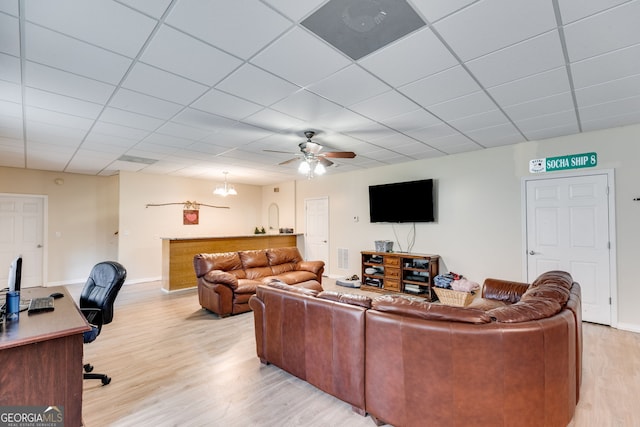 living room with a paneled ceiling, ceiling fan, and light wood-type flooring