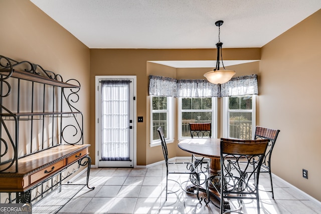 dining room with light tile patterned floors and a textured ceiling