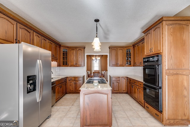 kitchen featuring sink, decorative backsplash, hanging light fixtures, a center island, and stainless steel appliances