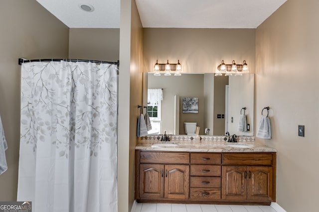 bathroom with vanity, toilet, and curtained shower