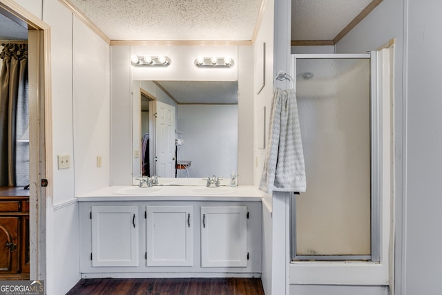 bathroom with crown molding, a textured ceiling, and walk in shower