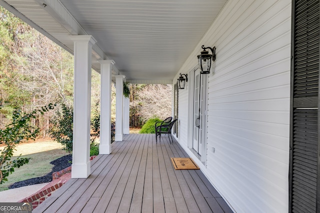 wooden terrace with a porch