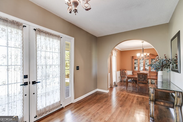 entrance foyer featuring a chandelier, hardwood / wood-style floors, and a textured ceiling