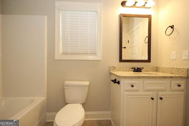 bathroom featuring vanity, toilet, and a bathing tub