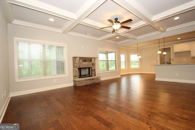 unfurnished living room featuring coffered ceiling, dark hardwood / wood-style flooring, beam ceiling, and a fireplace