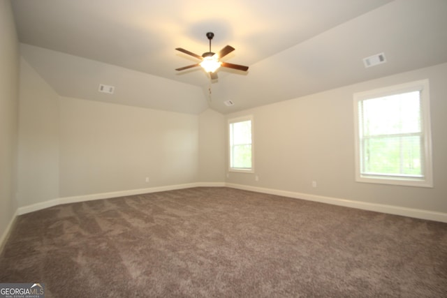 carpeted empty room with lofted ceiling and ceiling fan