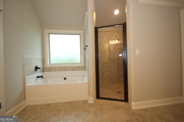 bathroom featuring shower with separate bathtub