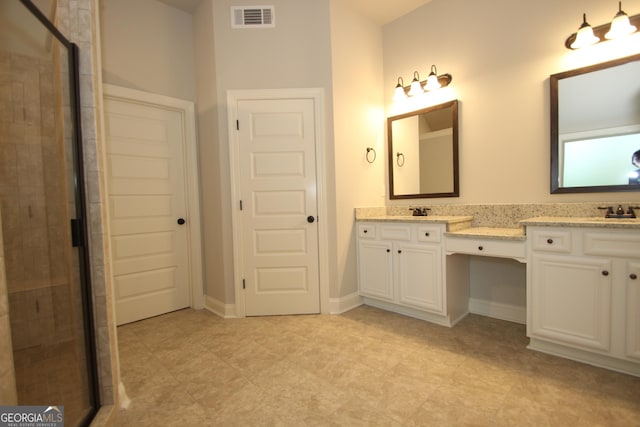 bathroom featuring vanity and a shower with shower door