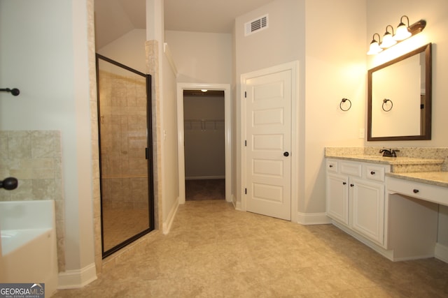 bathroom with vanity, independent shower and bath, and vaulted ceiling