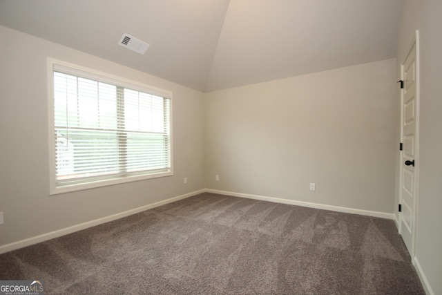 carpeted empty room with lofted ceiling