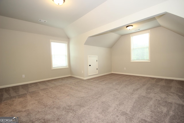 bonus room with carpet floors, vaulted ceiling, and a healthy amount of sunlight