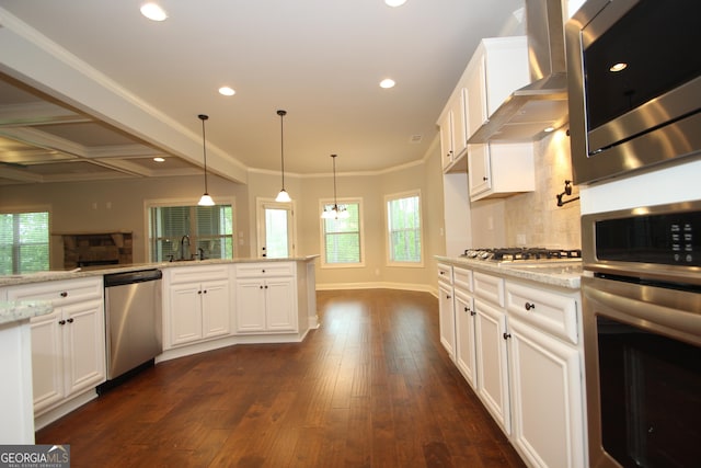 kitchen with wall chimney range hood, dark wood-type flooring, white cabinetry, stainless steel appliances, and light stone countertops