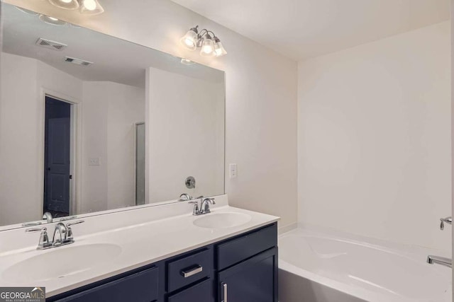 bathroom with vanity and a bathing tub