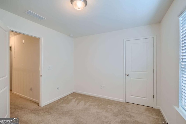 empty room featuring light colored carpet