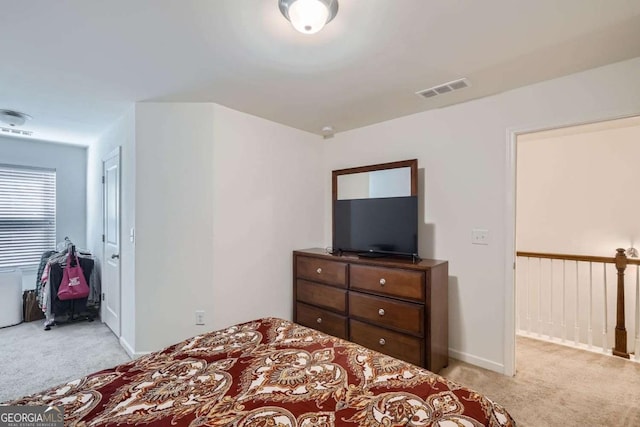 bedroom featuring light carpet