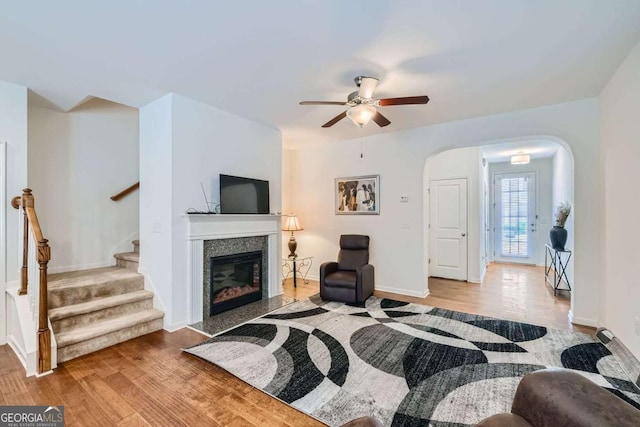 living room featuring ceiling fan and light hardwood / wood-style flooring