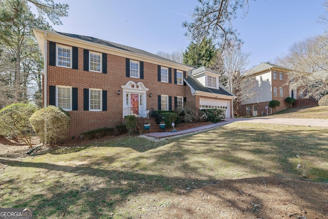 colonial house featuring concrete driveway, brick siding, and a front lawn