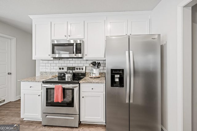 kitchen featuring appliances with stainless steel finishes and white cabinets