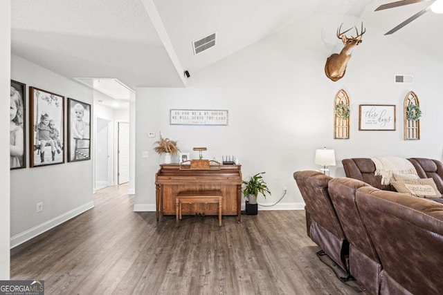 living room with vaulted ceiling, dark wood-type flooring, and ceiling fan