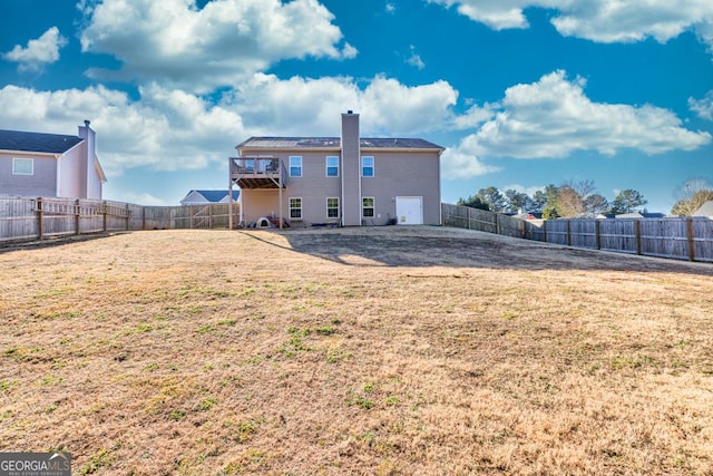 rear view of property with a yard