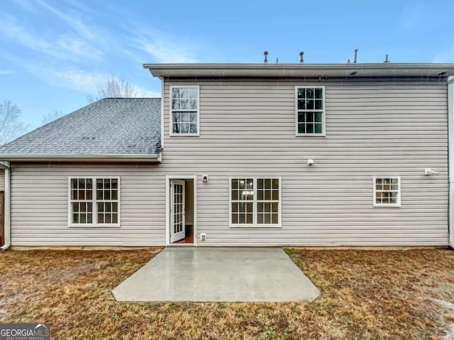 back of property featuring a patio and a lawn