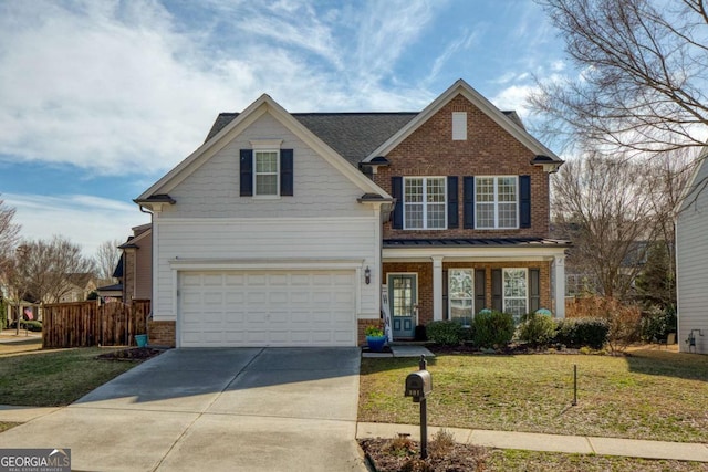 view of front facade with a garage, a front yard, and covered porch