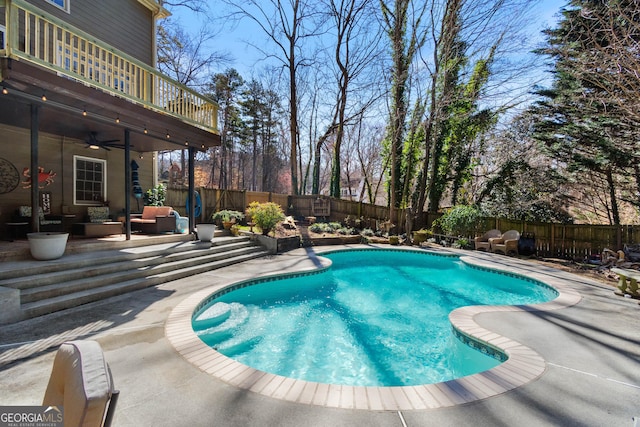 view of swimming pool featuring a patio area, an outdoor living space, and ceiling fan