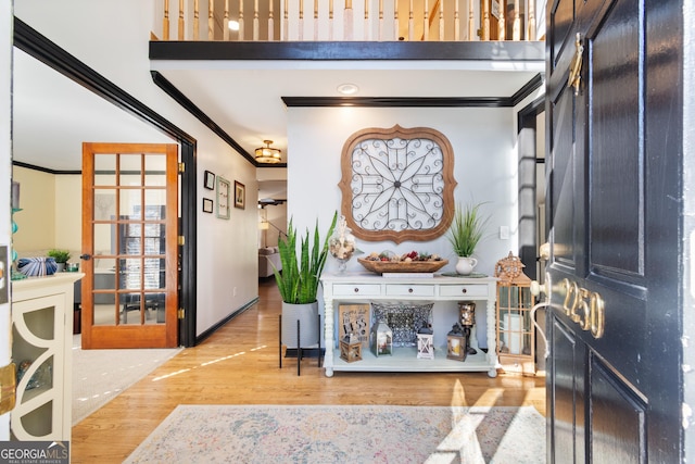 foyer featuring hardwood / wood-style floors and crown molding