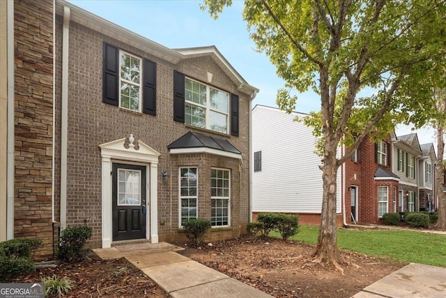 view of front of property with a front lawn and brick siding