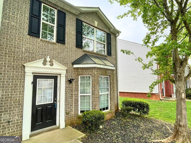 view of front of house with brick siding