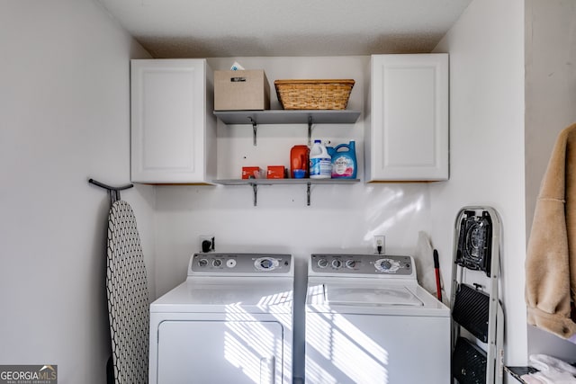 laundry room featuring cabinets and washing machine and clothes dryer