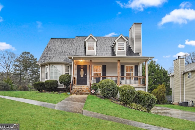 view of front facade with covered porch, cooling unit, and a front lawn