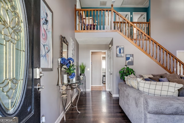 entryway with a high ceiling and dark hardwood / wood-style floors