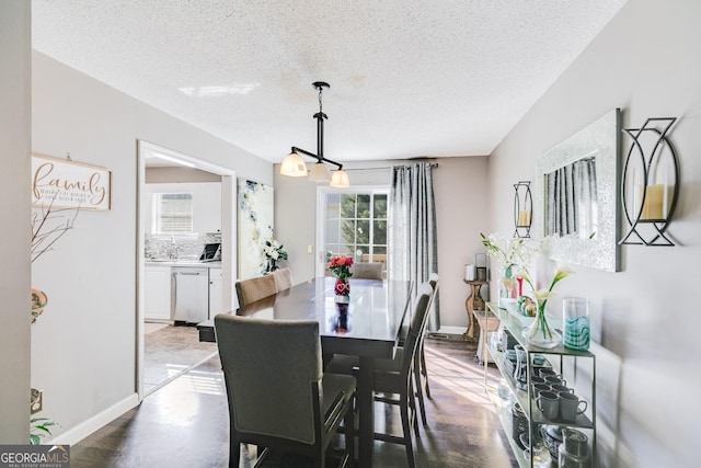 dining space featuring a textured ceiling