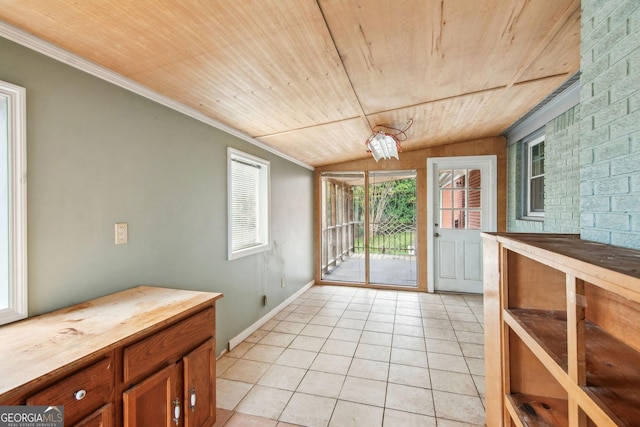 doorway to outside with ornamental molding, wooden ceiling, vaulted ceiling, and light tile patterned floors