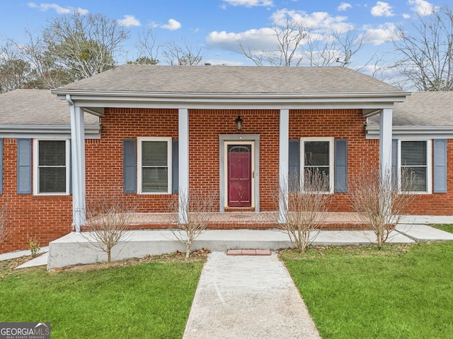 bungalow-style home featuring a porch, brick siding, and a shingled roof