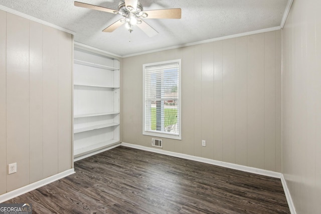 unfurnished room with dark wood finished floors, visible vents, ornamental molding, ceiling fan, and a textured ceiling