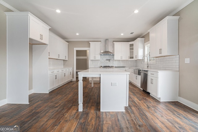 kitchen with wall chimney exhaust hood, a center island, dishwasher, and white cabinets