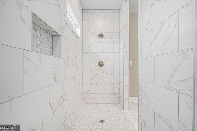 bathroom with a tile shower